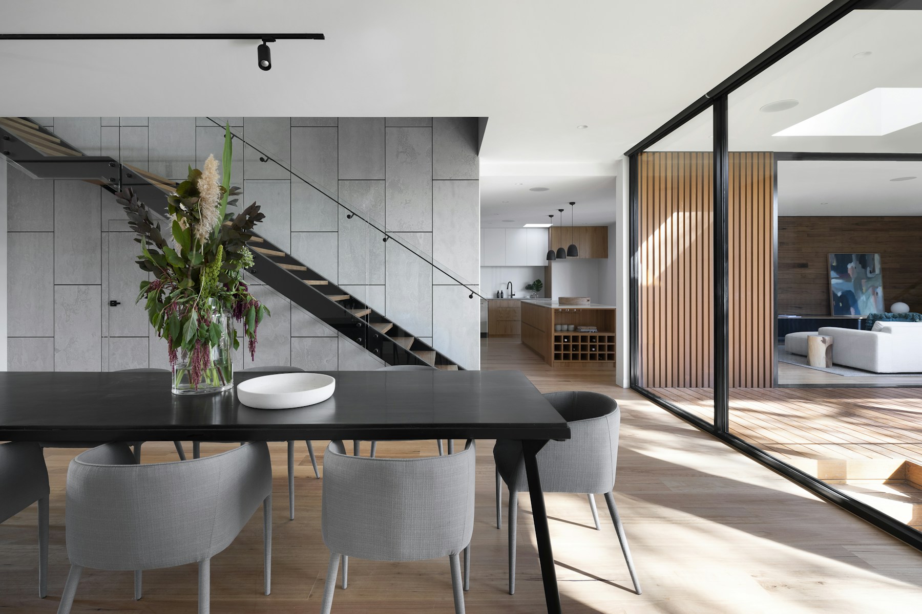 Light-filled contemporary home with natural wood, stone, and floor-to-ceiling windows